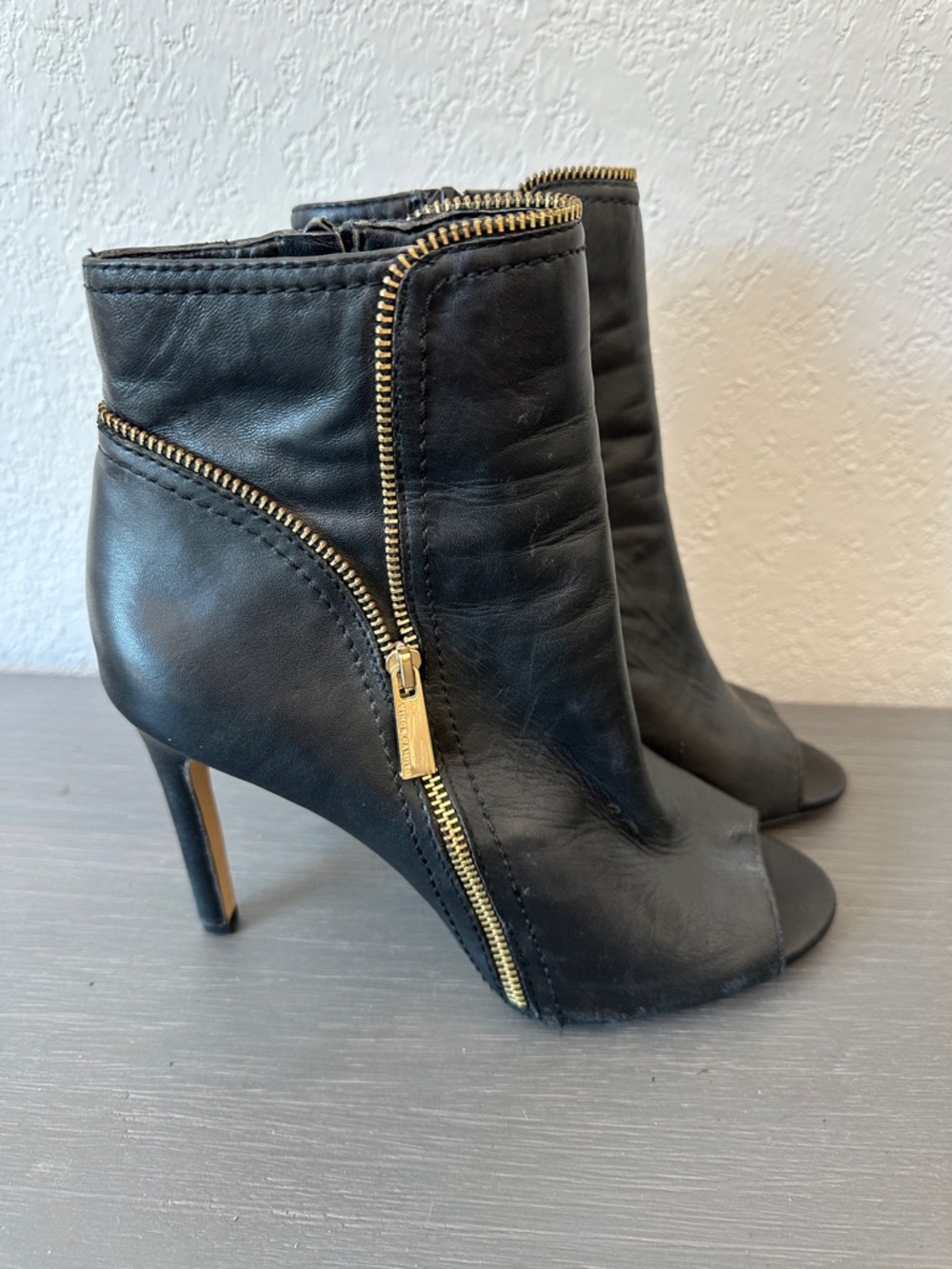 Vince Camuto Black Leather Peep-Toe Zip Ankle Boots with Gold Accents